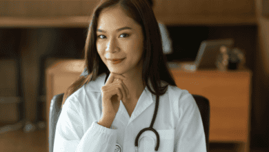 young female doctor looking into the camera wearing scrubs and a stethescope