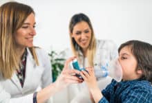 Doctor helping boy breath