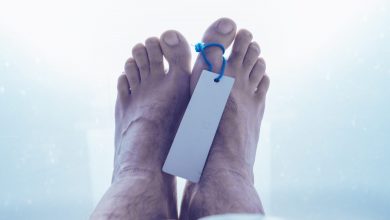 feet of dead male person in a morgue