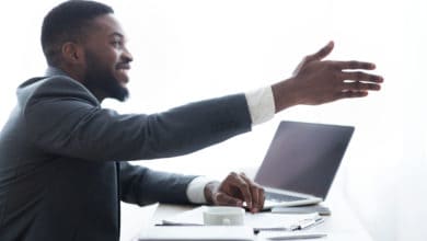 Friendly HR manager extending hand for handshake after successful interview