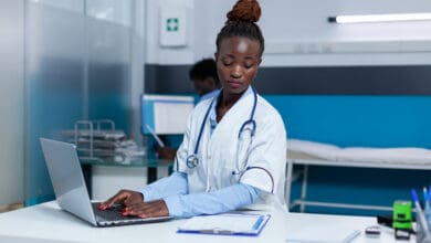 Clinic doctor specialist using computer to verify an AMCAS application