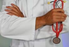 Doctor with arms crossed, holding a stethoscope.