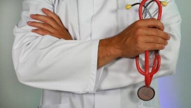 Doctor with arms crossed, holding a stethoscope.