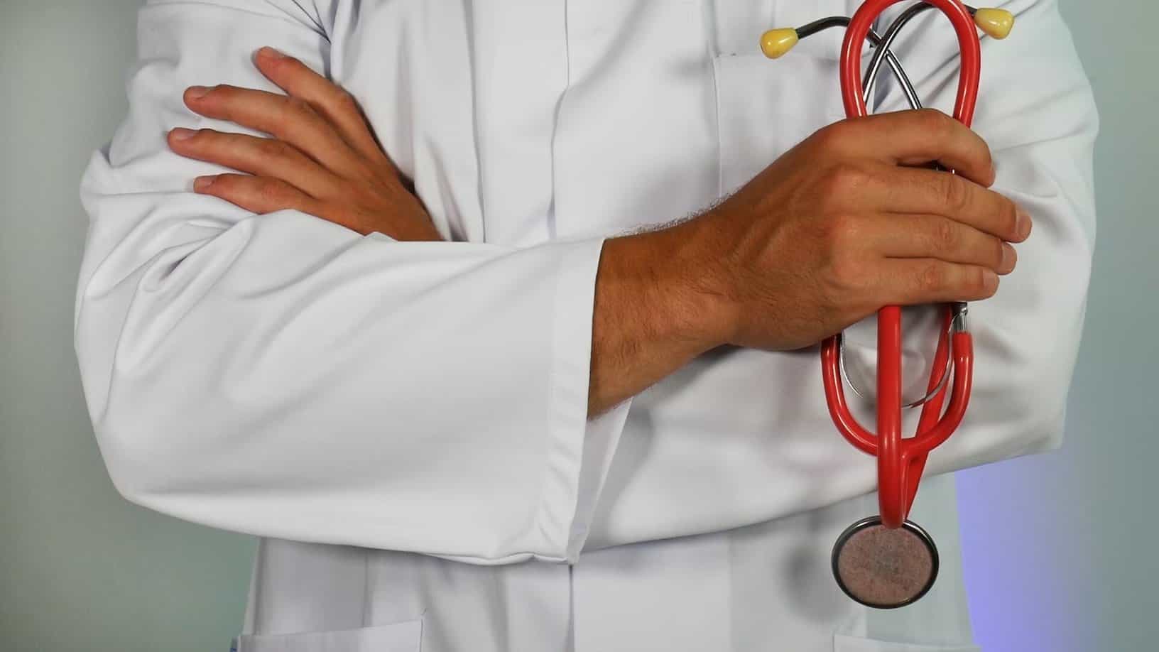 Doctor with arms crossed, holding a stethoscope.