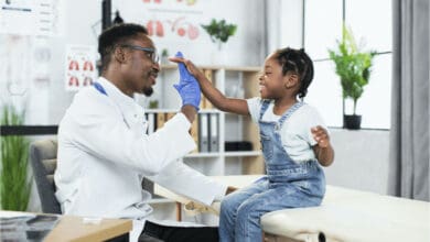 student doctor high fiving a pediatric patient during residency